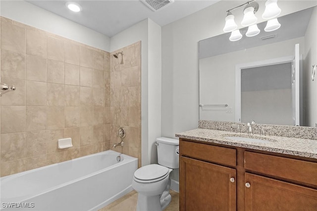 full bathroom with vanity, toilet, and tiled shower / bath