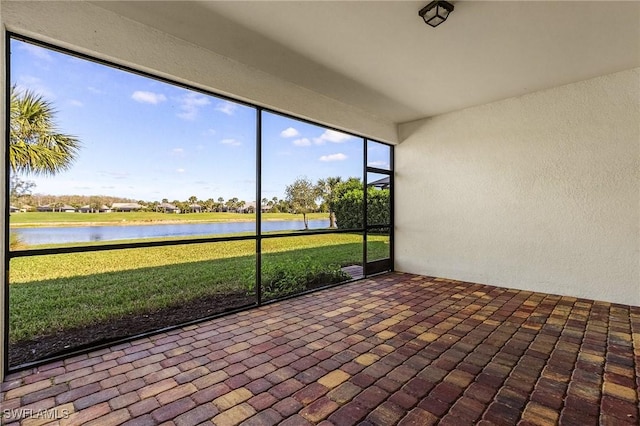 unfurnished sunroom with a water view