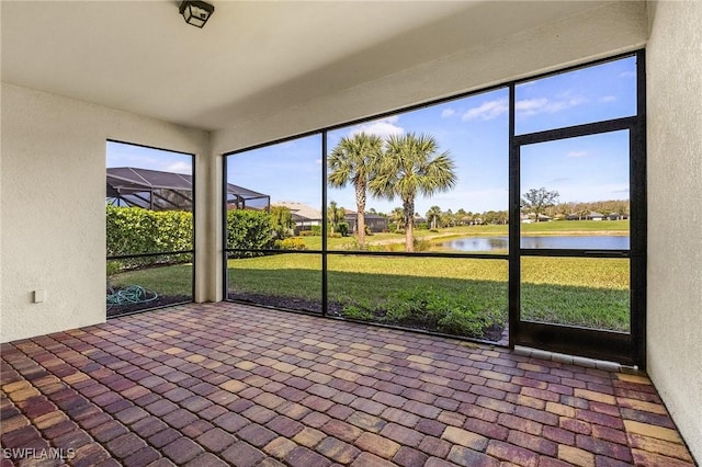 unfurnished sunroom with a water view