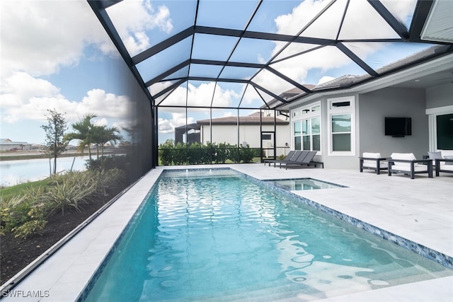 view of pool featuring glass enclosure, an in ground hot tub, a water view, and a patio