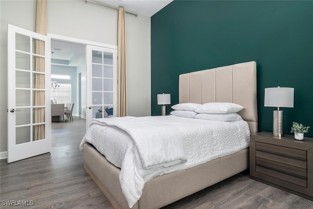 bedroom featuring french doors and dark hardwood / wood-style flooring