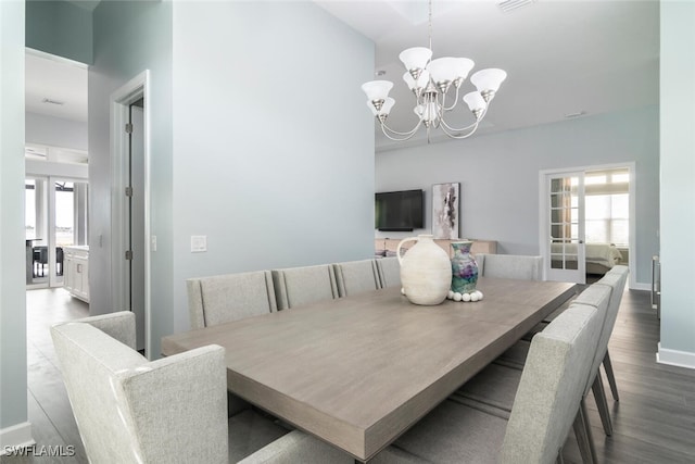 dining room featuring hardwood / wood-style flooring and an inviting chandelier