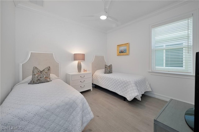 bedroom featuring hardwood / wood-style flooring, ceiling fan, and ornamental molding