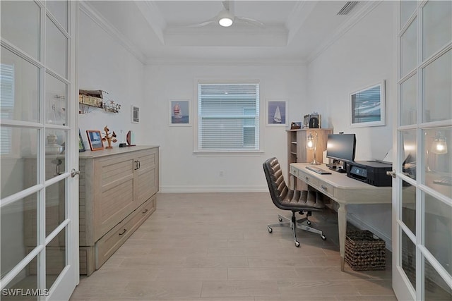 office with light hardwood / wood-style floors, a raised ceiling, crown molding, and french doors