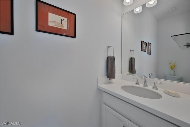 bathroom with vanity and toilet