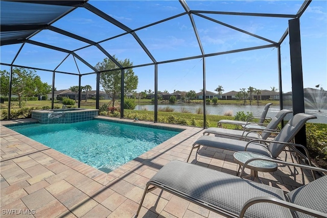 view of pool with glass enclosure, an in ground hot tub, a water view, and a patio