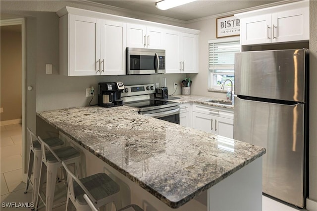 kitchen featuring white cabinets, sink, and stainless steel appliances