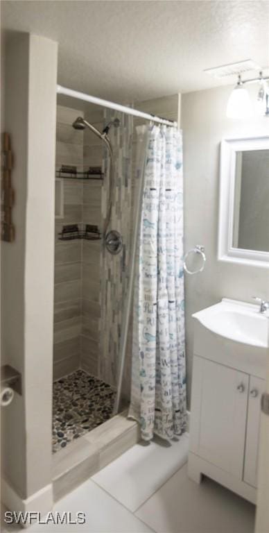 bathroom with a shower with shower curtain, vanity, and tile patterned floors