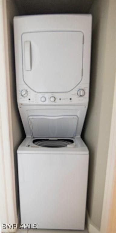 laundry room featuring stacked washer / dryer