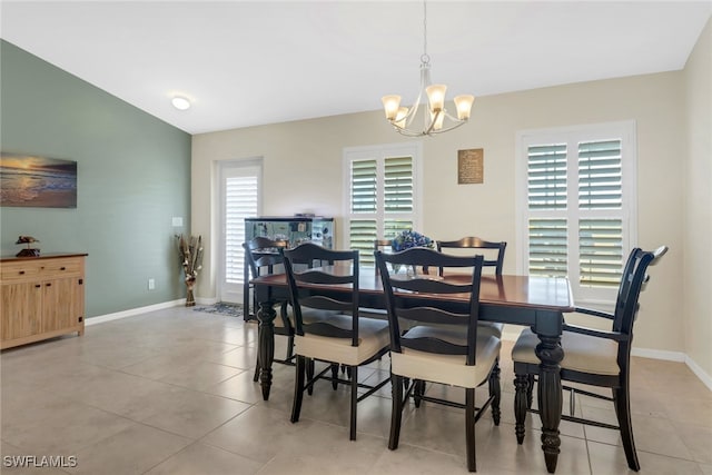 dining space featuring a wealth of natural light, light tile patterned flooring, and a chandelier