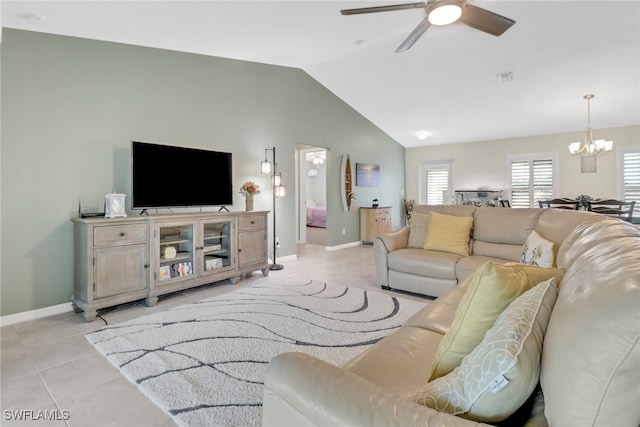 living room featuring light tile patterned floors, ceiling fan with notable chandelier, and vaulted ceiling