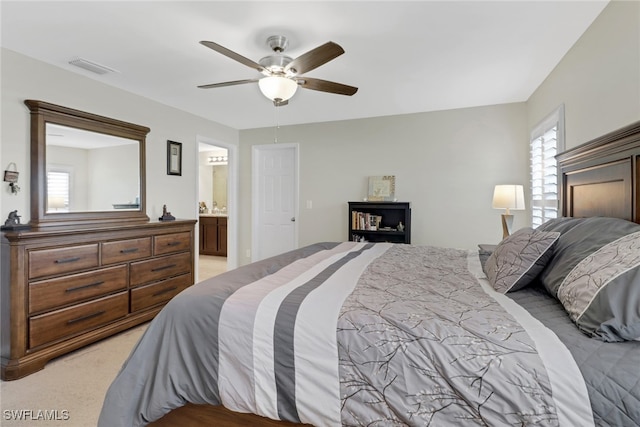 carpeted bedroom with ceiling fan and connected bathroom