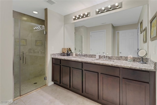 bathroom with vanity, tile patterned floors, and walk in shower