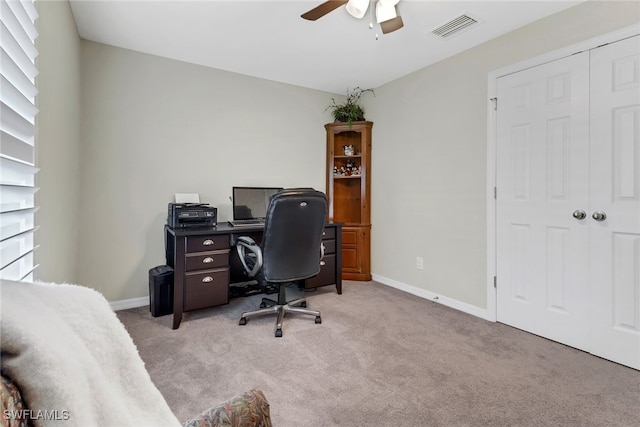 carpeted office space with ceiling fan