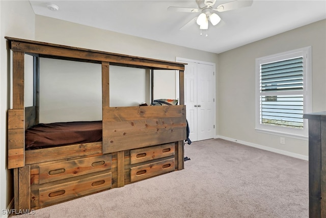 bedroom featuring ceiling fan and light carpet