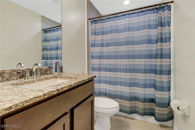 bathroom with walk in shower, vanity, and toilet