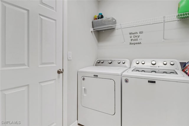 clothes washing area with washer and dryer