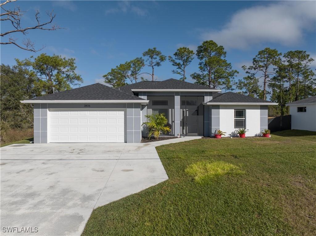 view of front of property with a garage and a front yard