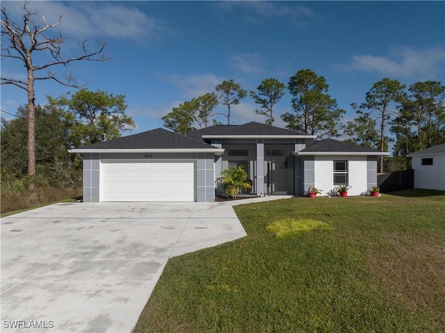 view of front of house with a garage and a front yard