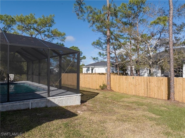 view of yard with glass enclosure and a fenced in pool