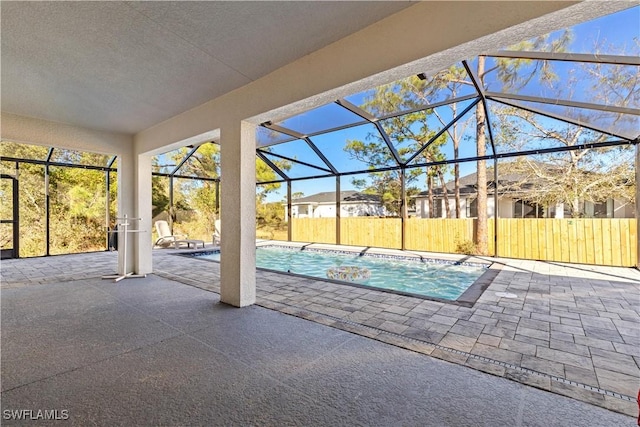 view of swimming pool with a lanai and a patio area