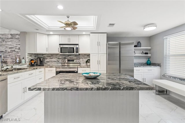 kitchen with white cabinets, sink, and appliances with stainless steel finishes