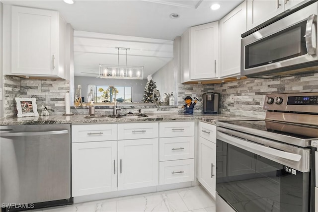 kitchen featuring decorative backsplash, white cabinetry, sink, and stainless steel appliances