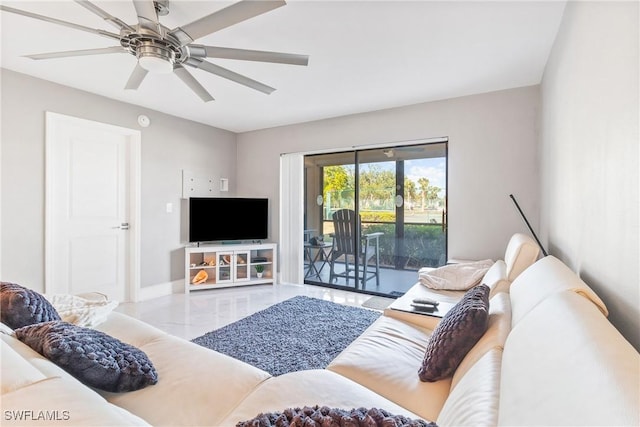 living room featuring ceiling fan and light tile patterned floors