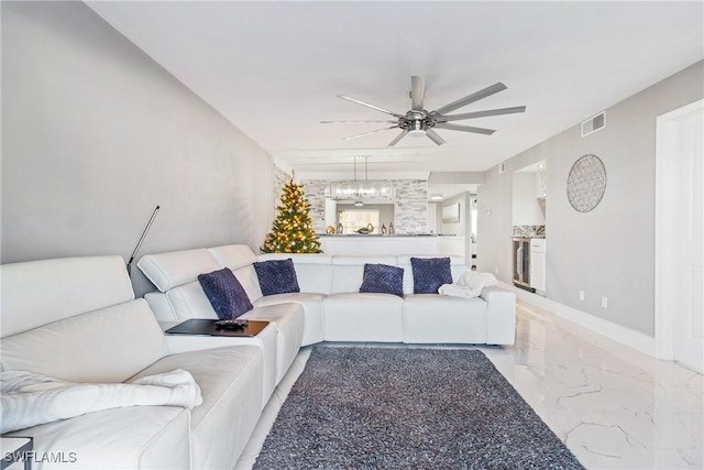 living room with wine cooler and ceiling fan with notable chandelier