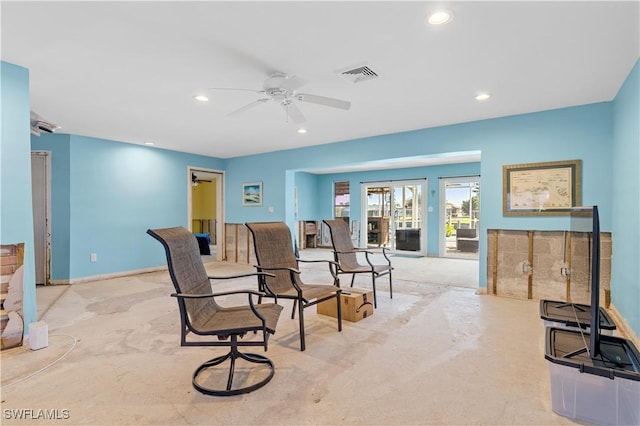 carpeted living room with ceiling fan