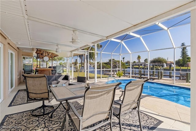 view of pool with a patio, ceiling fan, and a lanai