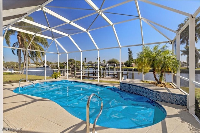 view of pool with glass enclosure, a water view, a patio, and a boat dock