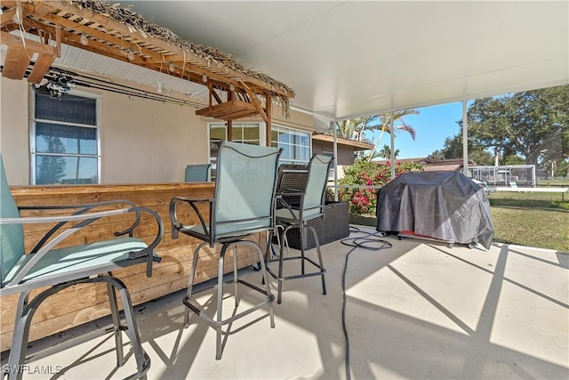 view of patio with a bar and grilling area