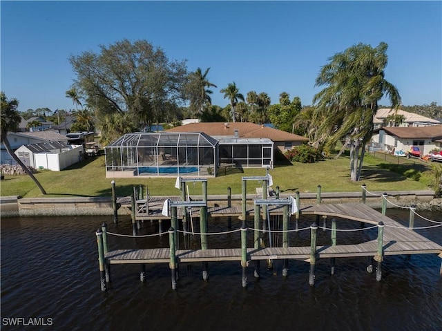 dock area featuring a lawn, glass enclosure, and a water view