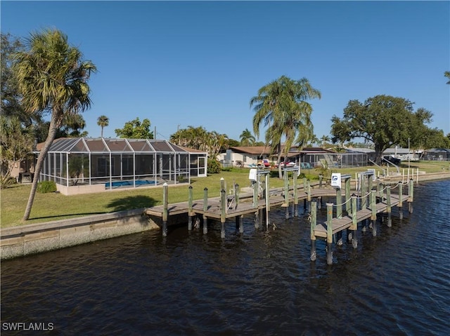 dock area featuring a lanai, a water view, and a yard