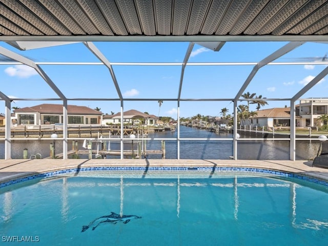 view of pool with a lanai, a dock, and a water view