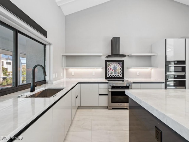 kitchen featuring white cabinetry, sink, high vaulted ceiling, range hood, and appliances with stainless steel finishes