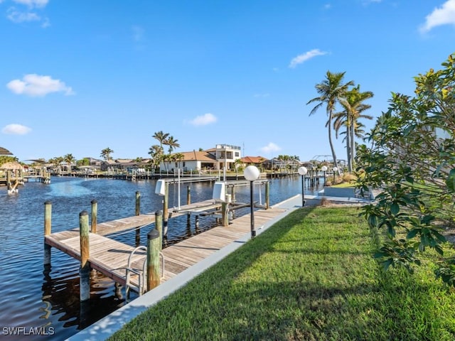 dock area featuring a yard and a water view