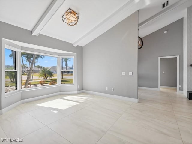 tiled spare room with lofted ceiling with beams