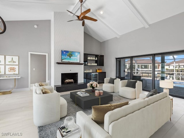 living room featuring a large fireplace, ceiling fan, high vaulted ceiling, beamed ceiling, and wine cooler