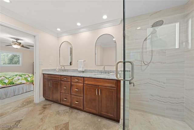 bathroom featuring a shower with door, crown molding, vanity, and ceiling fan