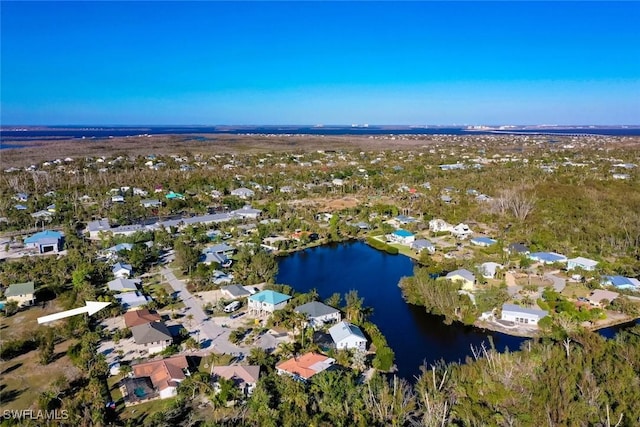 birds eye view of property with a water view and a residential view