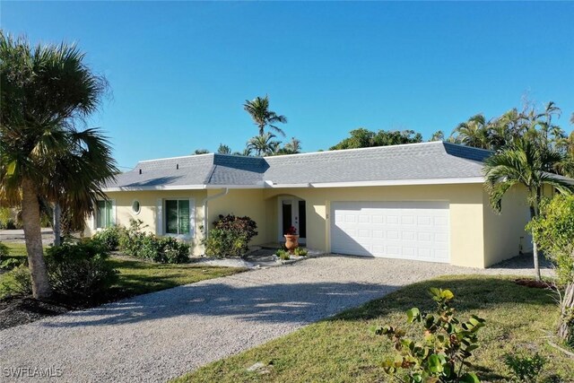 ranch-style home with a front yard and a garage