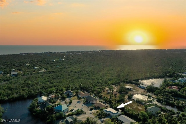 aerial view at dusk with a water view