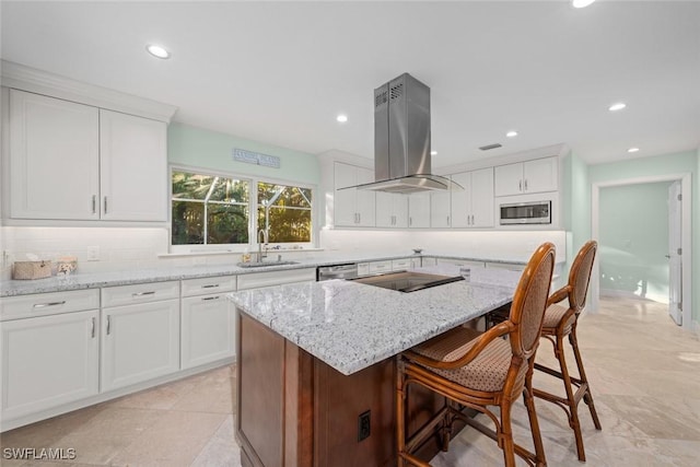 kitchen featuring sink, appliances with stainless steel finishes, white cabinetry, a center island, and island range hood