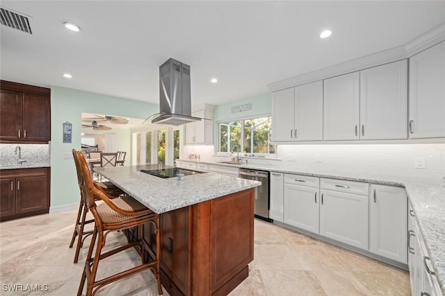 kitchen with a sink, exhaust hood, visible vents, decorative backsplash, and dishwasher