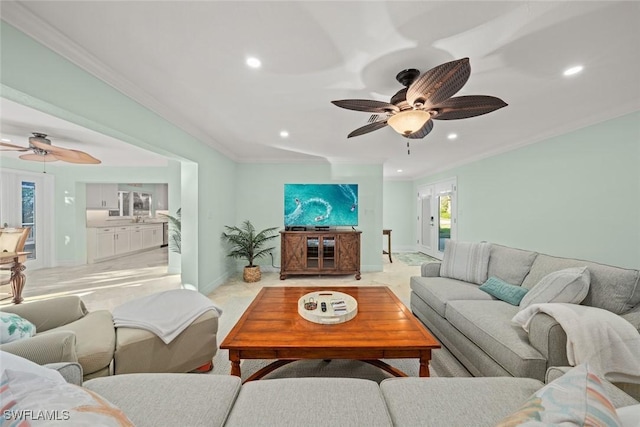 living room with ceiling fan, baseboards, crown molding, and recessed lighting