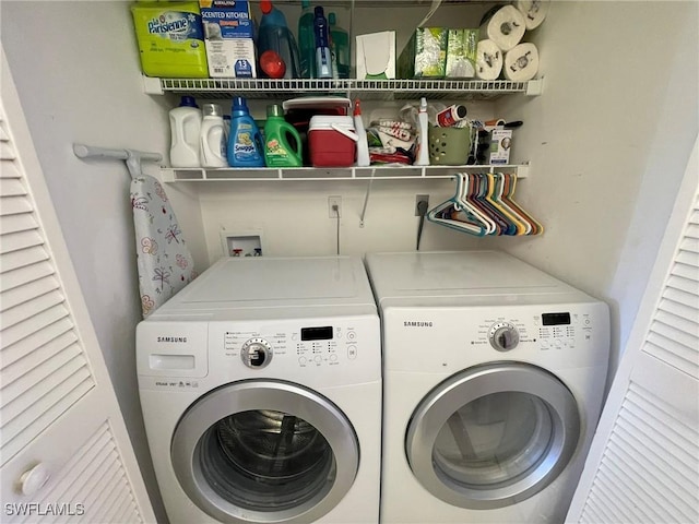 clothes washing area with washing machine and dryer