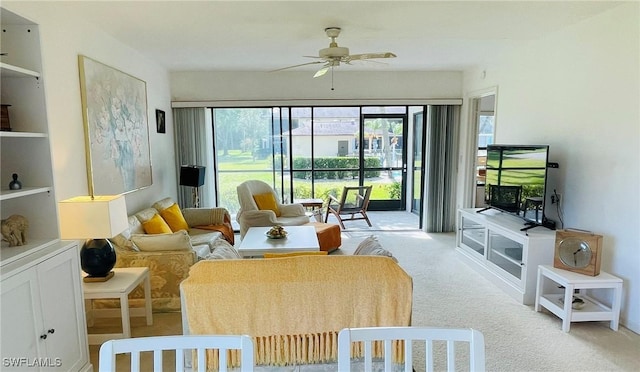 living room with light colored carpet and ceiling fan