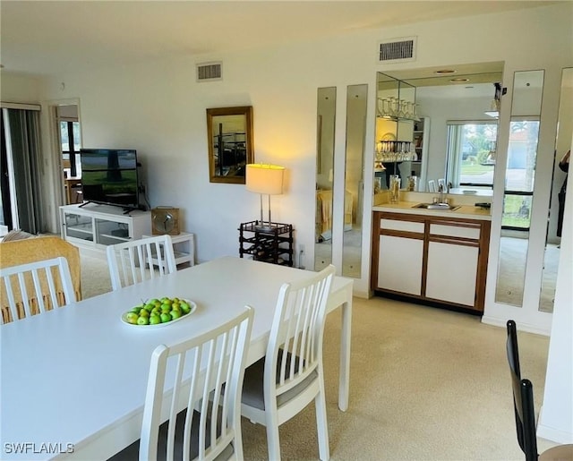 carpeted dining room featuring sink